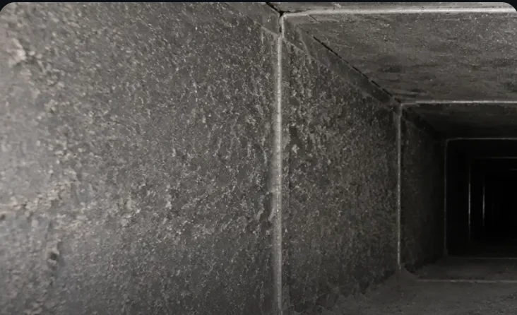Dust-caked HVAC duct interior before robotic cleaning — DCC field photo