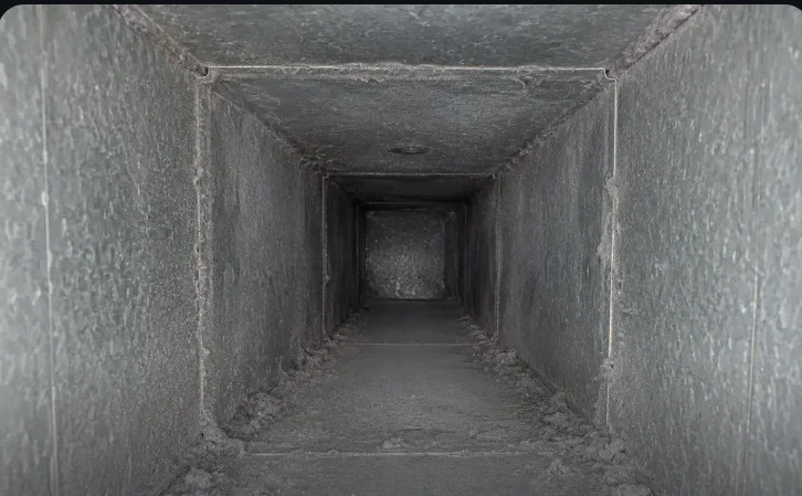 Lint-loaded laundry exhaust duct before cleaning — DCC field photo